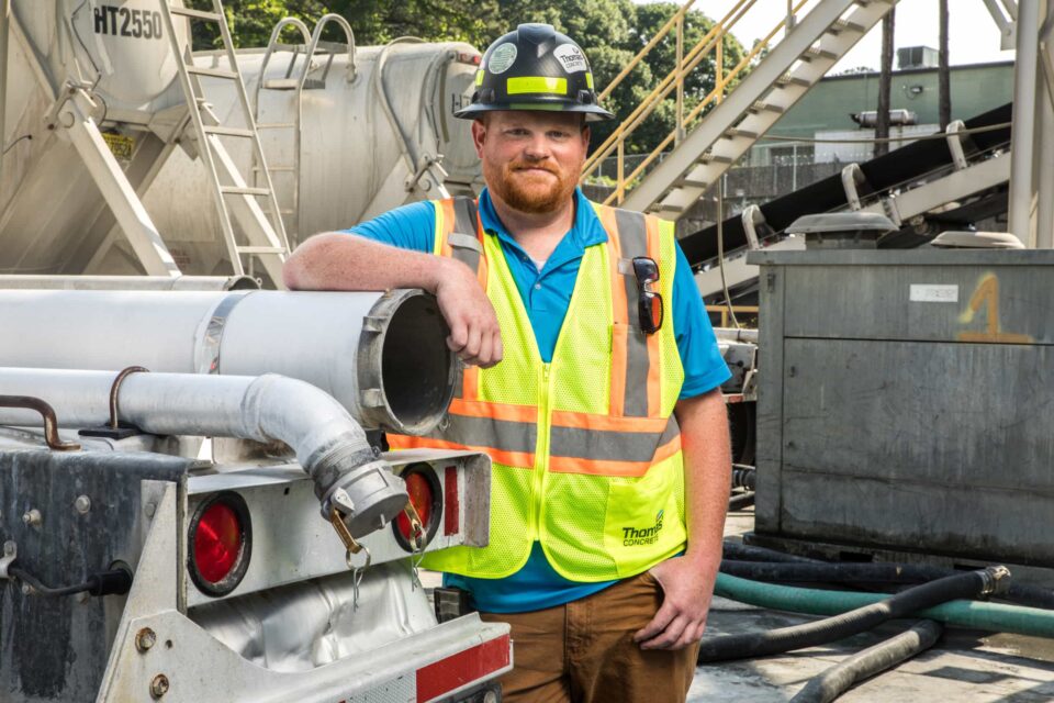 thomas-concrete-worker-beside-truck