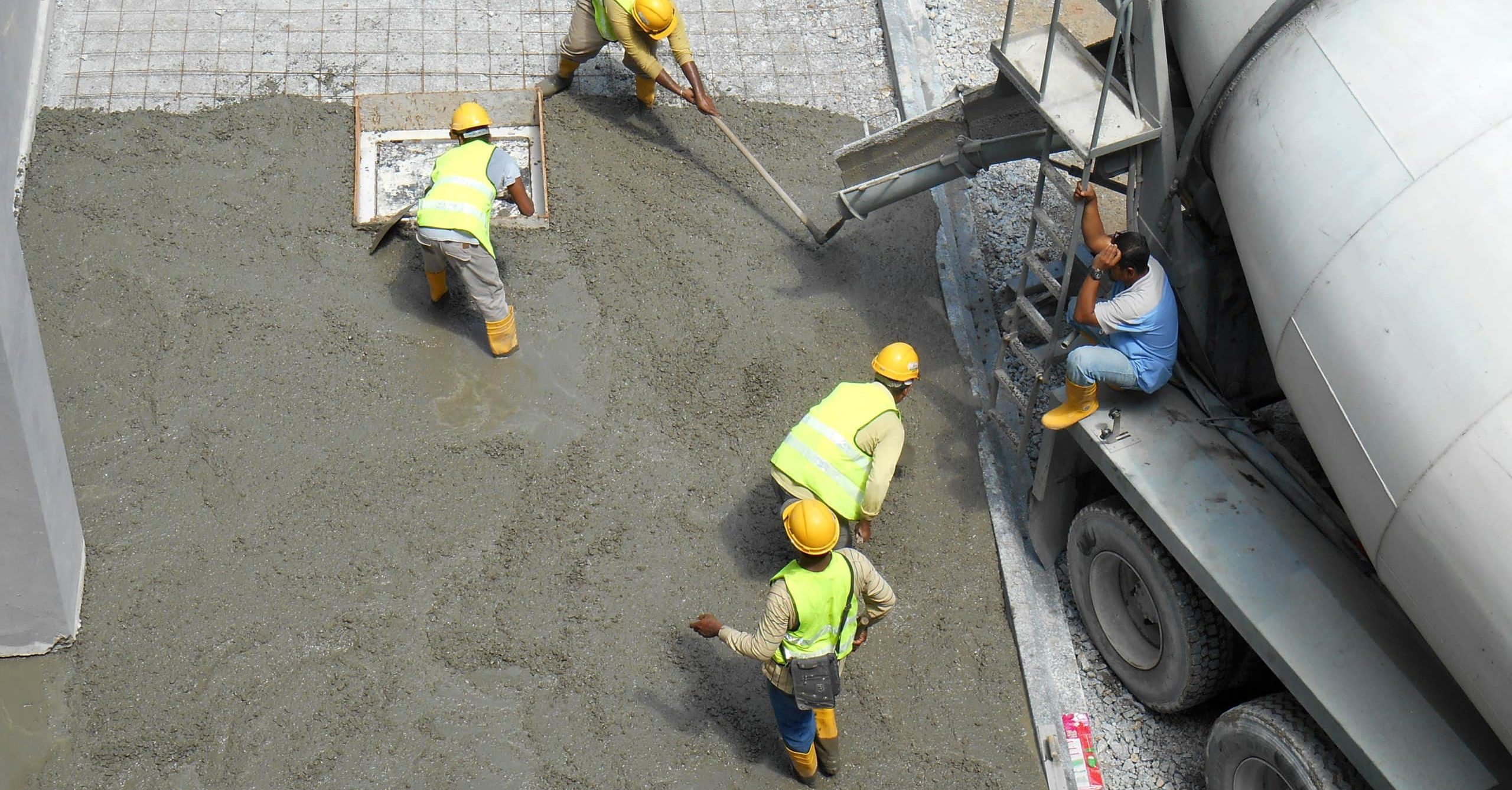 Construction Workers Leveling Wet Concrete Has Been Poured They Also Use A Vibrator Machine In This Work 