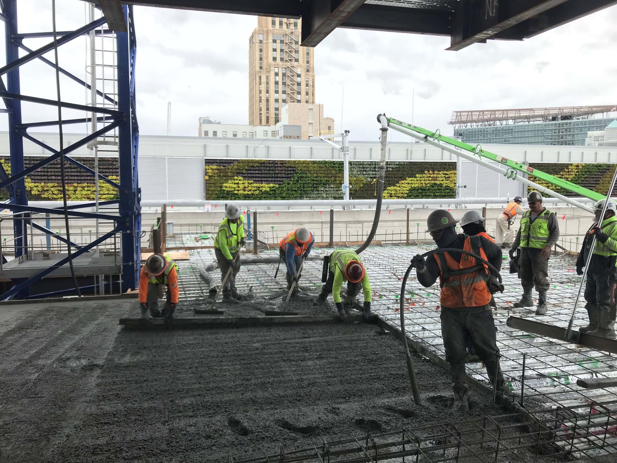 A construction crew pours low carbon concrete